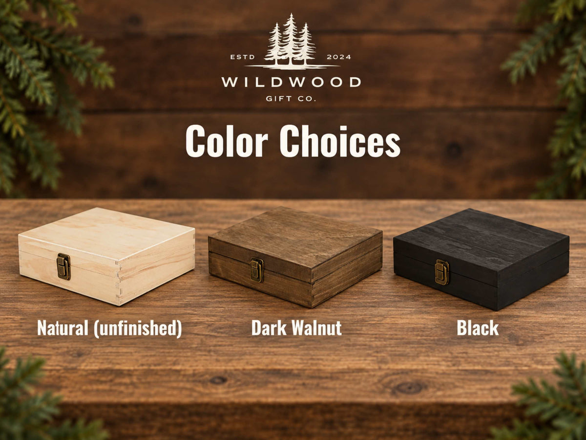 A color options graphic for Wildwood Gift Co. showing three wooden gift boxes on a rustic wood surface: a light natural unfinished box, a dark walnut brown box, and a black box.