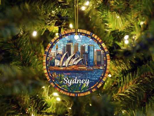 a stained glass ornament hanging from a christmas tree